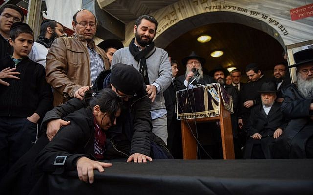 A mourner at the Jerusalem funeral for four Jewish victims of the Paris terror attacks, on January 13, 2015. (photo credit: Ben Kelmer/Flash90) A mourner at the Jerusalem funeral for four Jewish victims of the Paris terror attacks, on January 13, 2015. (photo credit: Ben Kelmer/Flash90)