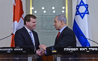 Prime Minister Benjamin Netanyahu (right) shakes hands with Canada's Minister of Foreign Affairs John Baird (left) in Jerusalem, on January 19, 2015. (photo credit: Kobi Gideon/GPO)