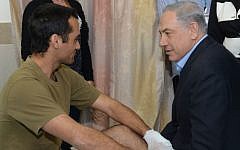 Prime Minister Benjamin Netanyahu visits wounded soldiers at Rambam hospital in Haifa, on January 30, 2015, following their injury in a January 28 Hezbollah attack in northern Israel near the Lebanese border. (Photo credit: Amos Ben Gershom/GPO)