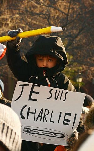 A young demonstrator holds up a  large pencil, during a rally Saturday, Jan. 10, 2015, at Washington Square Park in New York, in support of free expression and those killed during three days of violence in France. (photo credit: AP/Shoun A. Hill) 