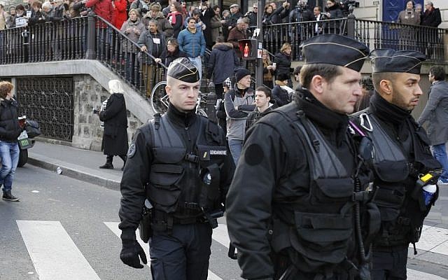 Police officers patrol near Republique square before a rally of defiance and sorrow, in Paris, France, Sunday, Jan. 11, 2015. The rally honored the 17 victims of three days of bloodshed in Paris that left France on alert for more violence. (photo credit: AP/Laurent Cipriani) Police officers patrol near Republique square before a rally of defiance and sorrow, in Paris, France, Sunday, Jan. 11, 2015. The rally honored the 17 victims of three days of bloodshed in Paris that left France on alert for more violence. (photo credit: AP/Laurent Cipriani)