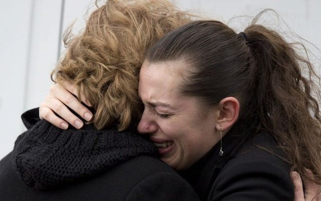 A woman cries outside a kosher grocery store, where four hostages were killed on Friday, in Paris, Saturday, Jan. 10, 2015. (photo credit: AP Photo/David Azia)