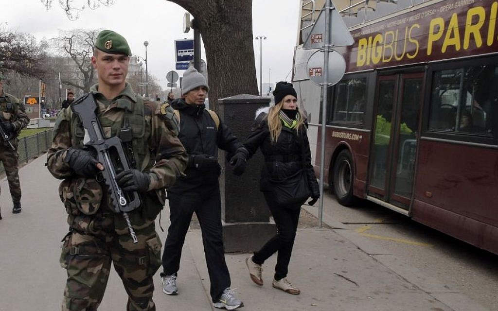 French soldiers patrol next to the Eiffel Tower after a shooting at a French satirical newspaper, in Paris, France, Wednesday, Jan. 7, 2015.  (photo credit: AP Photo/Christophe Ena)