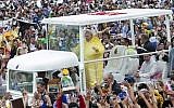 Pope Francis waves to the crowd as he arrives at Quirino Grandstand to celebrate his final Papal Mass in Manila, Philippines, Sunday, Jan. 18, 2015. (AP Photo/Ron Soliman)