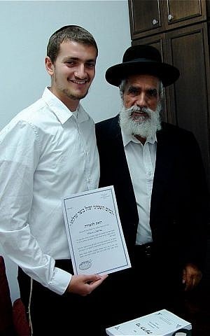 Rabbi Gabriel Negrin given his certification as mohel, or ritual circumciser, with Rabbi Shlomo Makhpud. (courtesy)