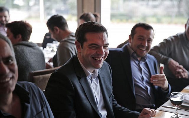Alexis Tsipras, leader of Greece's Syriza left-wing main opposition party, enjoys a lunch with colleagues and journalists in central Athens, Saturday, Jan. 24, 2015 (photo credit: AP/Lefteris Pitarakis)