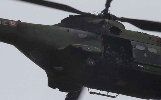 French soldiers sit in a helicopter flying over Dammartin-en-Goele where a hostage-taking was underway after police hunting the Islamist brothers who killed 12 people earlier this week exchanged fire with two men during a car chase, on January 9, 2015. (photo credit: AFP PHOTO / JOEL SAGET) French soldiers sit in a helicopter flying over Dammartin-en-Goele where a hostage-taking was underway after police hunting the Islamist brothers who killed 12 people earlier this week exchanged fire with two men during a car chase, on January 9, 2015. (photo credit: AFP PHOTO / JOEL SAGET)