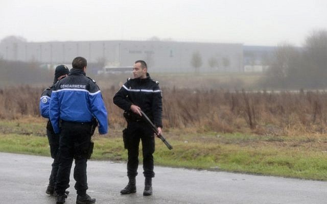 French gendarmes patrol in Dammartin-en-Goele where a hostage-taking was underway after police hunting the Islamist brothers who killed 12 people earlier this week exchanged fire with two men during a car chase, on January 9, 2015. (photo credit:AFP PHOTO / JOEL SAGET) French gendarmes patrol in Dammartin-en-Goele where a hostage-taking was underway after police hunting the Islamist brothers who killed 12 people earlier this week exchanged fire with two men during a car chase, on January 9, 2015. (photo credit:AFP PHOTO / JOEL SAGET)