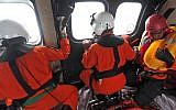 Crew members of Indonesian Air Force NAS 332 Super Puma helicopter look out of the windows during a search operation for the victims of AirAsia Flight 8501 over the Java Sea, Indonesia, Sunday, Jan. 4, 2015.  (Photo credit: AP/Adi Weda, Pool)