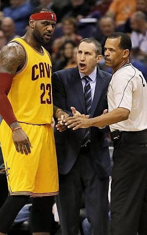 Cleveland Cavaliers' LeBron James, left, and head coach David Blatt argue with a referee during the first half of an NBA basketball game against the Phoenix Suns in Phoenix, January 13, 2015.  (photo credit: AP Photo/Matt York, File)