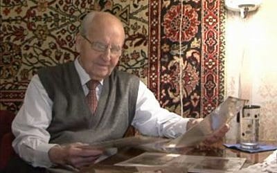 Ivan Martynushkin, who helped liberate Auschwitz, looking at old papers recently. (Screen capture: AFP)