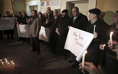 Palestinian leaders of civil society groups hold a candlelight vigil in solidarity with France outside the French Cultural Center in Gaza City, Sunday, Jan. 11, 2015. (photo credit: AP/Khalil Hamra) 
