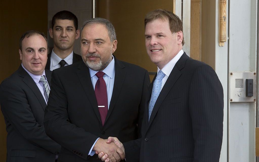 Israeli Foreign Minister Avigdor Lieberman, center left, shakes hands with his Canadian counterpart John Baird during their meeting in Jerusalem, Sunday, Jan. 18, 2015. (photo credit: AP Photo/Sebastian Scheiner)