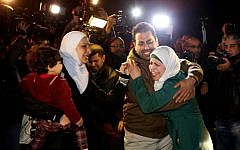 The sister, right, and wife, left, of Jordanian pilot Lt. Muath al-Kaseasbeh, who is held by the Islamic State group militants, cry at a protest in front of the Royal Palace in Amman, Jan. 28, 2015. Jordan offered a first-ever prisoner swap to the terrorist group to save al-Kaseasbeh, along with a Japanese hostage. (Photo credit: Raad Adayleh/AP)