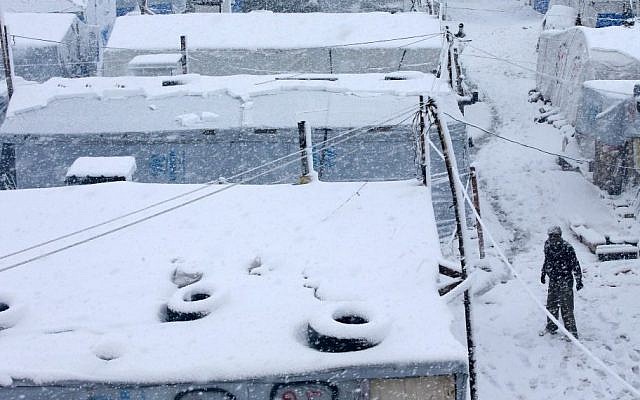 A Syrian man, right, walks between tents covered in snow at a refugee camp in Deir Zannoun village, in the Bekaa valley, east Lebanon, Wednesday, Jan. 7, 2015. (Photo credit: AP/Hussein Malla) A Syrian man, right, walks between tents covered in snow at a refugee camp in Deir Zannoun village, in the Bekaa valley, east Lebanon, Wednesday, Jan. 7, 2015. (Photo credit: AP/Hussein Malla)