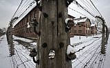 Barbed wire fences surround detention buildings at the Auschwitz Nazi death camp in Oswiecim, Poland, Monday, Jan. 26, 2015 (AP Photo/Alik Keplicz)