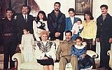 Raghad, in the blue blazer, holds her baby in this photograph of the Saddam Hussein family from 1980s. Her new jewelry line was inspired by her father and her husband (Wikimedia Commons)