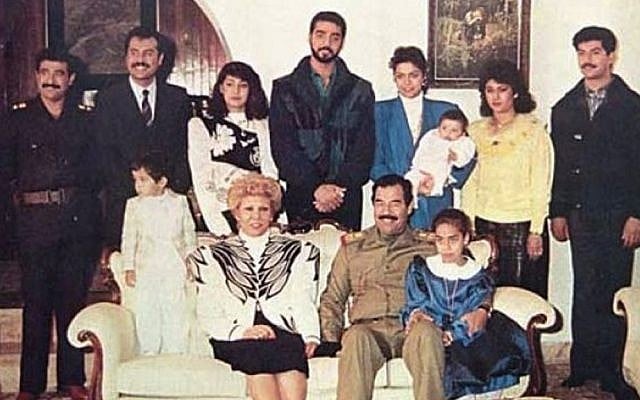 Raghad, in the blue blazer, holds her baby in this photograph of the Saddam Hussein family from 1980s. Her new jewelry line was inspired by her father and her husband (Wikimedia Commons) Raghad, in the blue blazer, holds her baby in this photograph of the Saddam Hussein family from 1980s. Her new jewelry line was inspired by her father and her husband (Wikimedia Commons)