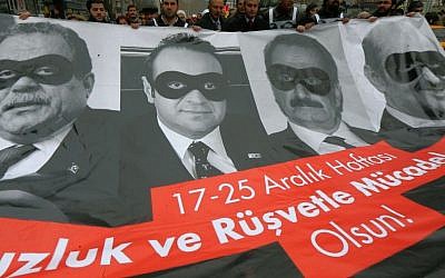 Lawmakers and officials from the main opposition Republican People's Party, CHP, carry posters with images of former Turkish ministers during a protest in Ankara, Turkey, Dec. 17, 2014. (photo credit: AP/File)