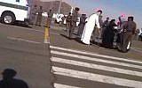 Illustrative: A woman is seen kneeling on the ground ahead of her execution in Saudi Arabi as a swordsman dressed in white stands above her, January 17, 2015. (Screen Capture: YouTube)