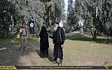 An illustrative, undated picture of a woman in a niqab led by Islamic State members to her stoning after being accused of infidelity (Photo credit: YouTube screenshot)