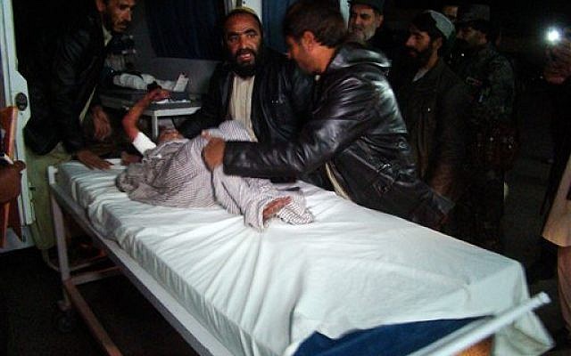 An Afghan wounded child is helped by people at a hospital in Helmand province, south of Kabul, Afghanistan, Wednesday, Dec. 31, 2014 (photo credit: AP Photo/Abdul Khaliq) An Afghan wounded child is helped by people at a hospital in Helmand province, south of Kabul, Afghanistan, Wednesday, Dec. 31, 2014 (photo credit: AP Photo/Abdul Khaliq)