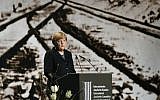 German Chancellor Angela Merkel stands in front of a historic picture of the Auschwitz concentration camp as she gives a speech during the International Auschwitz Committee’s remembrance ceremony in Berlin to mark the 70th anniversary of the liberation of the Nazi death camp, on January 26, 2015. (photo credit: AFP/Tobias Schwarz)