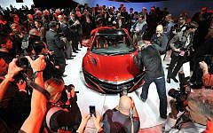 Journalists photograph the new Acura NSX vehicle at the 2015 North American International Auto Show (Photo credit: Courtesy NAIAS)