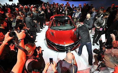 Journalists photograph the new Acura NSX vehicle at the 2015 North American International Auto Show (Photo credit: Courtesy NAIAS)