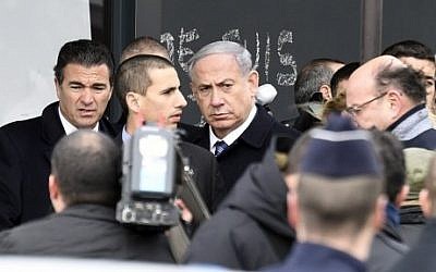 Israel's Prime Minister Benjamin Netanyahu (C) arrives at a kosher grocery store in Porte de Vincennes, eastern Paris, on January 12, 2015. (photo credit: Martin Bureau/AFP)