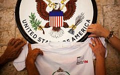 A photo of Palestinian supporters raising a t-shirt to the US Consulate General sign in Jerusalem on September 21, 2011 (AP Photo/ Dusan Vranic)