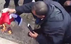 Demonstrators burn the French flag on the Temple Mount on January 16, 2015 after Friday prayers at the al-Aqsa Mosque in Jerusalem to  protest the depiction of the Prophet Muhammad in the French publication Charlie Hebdo this week. (screen capture: Shehab News Agency/Facebook)