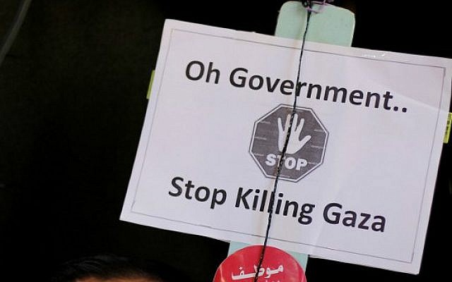 A sign held by a Palestinian employees of the former Hamas government (not pictured) during a protest at the gate of the Palestinian unity government cabinet headquarters in Gaza, January 13, 2015 (photo credit: AFP/MOHAMMED ABED) A sign held by a Palestinian employees of the former Hamas government (not pictured) during a protest at the gate of the Palestinian unity government cabinet headquarters in Gaza, January 13, 2015 (photo credit: AFP/MOHAMMED ABED)