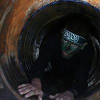 Illustrative: A Palestinian youth crawls in a tunnel during a graduation ceremony for a training camp run by the Hamas movement on January 29, 2015, in Khan Yunis, in the southern Gaza Strip. (AFP photo/Said Khatib) Illustrative: A Palestinian youth crawls in a tunnel during a graduation ceremony for a training camp run by the Hamas movement on January 29, 2015, in Khan Yunis, in the southern Gaza Strip. (AFP photo/Said Khatib)