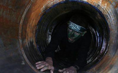 Illustrative: A Palestinian youth crawls in a tunnel during a graduation ceremony for a training camp run by the Hamas movement on January 29, 2015, in Khan Yunis, in the southern Gaza Strip. (AFP photo/Said Khatib)