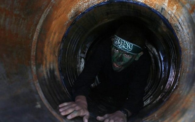 Illustrative: A Palestinian youth crawls in a tunnel during a graduation ceremony for a training camp run by the Hamas movement on January 29, 2015, in Khan Yunis, in the southern Gaza Strip. (AFP photo/Said Khatib) Illustrative: A Palestinian youth crawls in a tunnel during a graduation ceremony for a training camp run by the Hamas movement on January 29, 2015, in Khan Yunis, in the southern Gaza Strip. (AFP photo/Said Khatib)