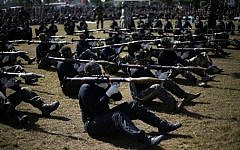 Palestinian youth show their skills during a graduation ceremony as part of a training camp run by the Hamas movement on January 29, 2015 in Khan Yunis, in the southern Gaza Strip. (AFP photo/Said Khatib)