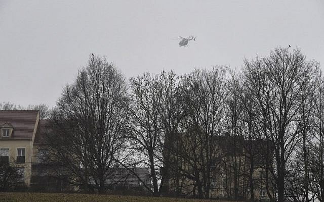 A helicopter flies over Dammartin-en-Goele, where shots were fired and at least one hostage was taken in the same area where police were hunting for the two brothers accused of slaughtering 12 people in an Islamist assault, on January 9, 2015. (photo credit: AFP/Dominique Faget) A helicopter flies over Dammartin-en-Goele, where shots were fired and at least one hostage was taken in the same area where police were hunting for the two brothers accused of slaughtering 12 people in an Islamist assault, on January 9, 2015. (photo credit: AFP/Dominique Faget)