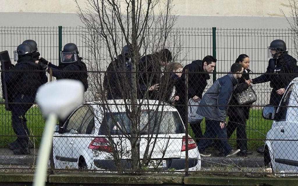 French police special forces evacuate local residents on January 9, 2015 in Saint-Mande, near Porte de Vincennes, eastern Paris, after at least one person was injured when a gunman opened fire at a kosher grocery store on January 9, 2015 and took at least five people hostage, sources told AFP. The attacker was suspected of being the same gunman who killed a policewoman in a shooting in Montrouge in southern Paris on January 8. (photo credit: AFP/ Martin Bureau)