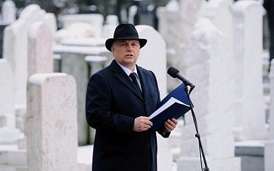 Hungarian Prime Minister Viktor Orban gives a speech in front of renovated Jewish graves at the Kozma street Jewish cemetery in Budapest, on January 26, 2015 during a ceremony for the grave refurbishment on the eve of the 70th anniversary of the liberation of the Auschwitz death camp held by the Nazis during WWII. (Photo credit: AFP/ ATTILA KISBENEDEK)