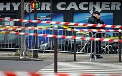 Two French security officers standing guard on January 10, 2015, the day after a terror attack on a kosher market in Paris. (AP Photo/Peter Dejong)