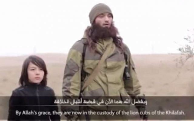 A young boy (L) seen executing two alleged Russian spies in a video released by the Islamic State group, January 2015. (screen capture: YouTube/Basekasl Oacska) A young boy (L) seen executing two alleged Russian spies in a video released by the Islamic State group, January 2015. (screen capture: YouTube/Basekasl Oacska)