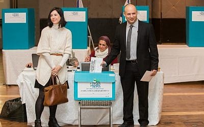 Jewish Home party leader Naftali Bennett (R) and his wife, Gilat seen cast their vote during the party's preliminary elections, in Jerusalem, on January 14, 2014 (photo credit: Yonatan Sindel/Flash90)