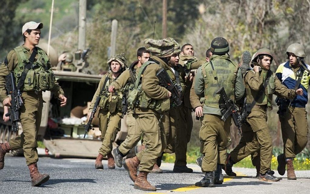Israeli soldiers seen being taken care of when an Israeli army patrol came under anti-tank fire from Hezbollah operatives in the northern Mount Dov region along the Israeli border with Lebanon on January 28, 2015. (Photo credit: Basal Awidat/Flash90)