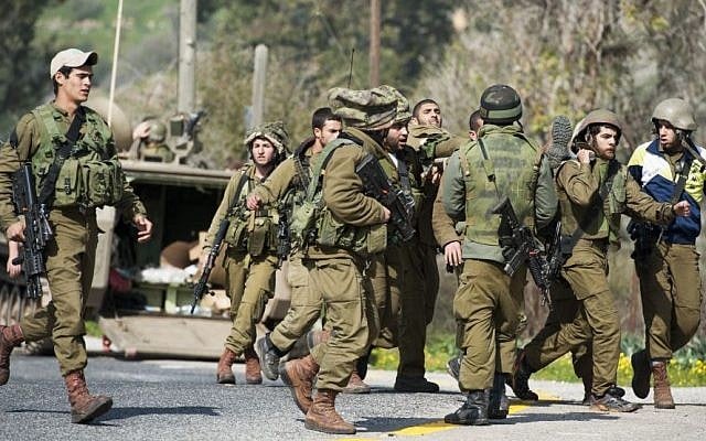 Israeli soldiers seen being taken care of when an Israeli army patrol came under anti-tank fire from Hezbollah operatives in the northern Mount Dov region along the Israeli border with Lebanon on January 28, 2015. (Photo credit: Basal Awidat/Flash90) 
