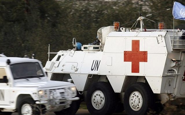 Spanish soldiers of the United Nations Interim Force in Lebanon (UNIFIL) drive an armored emergency vehicle after picking up the body of a 36-year-old UN peacekeeper from Spain who was killed as the Israeli military shelled border areas following a Hezbollah attack that left two Israeli soldiers dead. (Photo credit: AFP/MAHMOUD ZAYYAT)