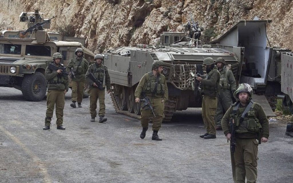 IDF soldiers secure the Israel-Lebanon border, Wednesday, Jan. 28, 2015 after Hezbollah attacked an Israeli military convoy, killing two soldiers. (Photo credit: AP/Ariel Schalit)