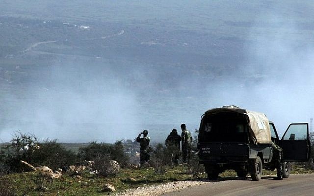A Lebanese army soldier uses his binoculars as smoke from Israeli shelling covers the Lebanese town of Al-Majidiyah on the Lebanese border with Israel in the Wazzani area on January 28, 2015. Hezbollah claimed responsibility on Wednesday for an attack against an IDF convoy near the Lebanon border. Photo credit: AFP/ ALI DIA) A Lebanese army soldier uses his binoculars as smoke from Israeli shelling covers the Lebanese town of Al-Majidiyah on the Lebanese border with Israel in the Wazzani area on January 28, 2015. Hezbollah claimed responsibility on Wednesday for an attack against an IDF convoy near the Lebanon border. Photo credit: AFP/ ALI DIA)