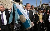 Foreign Minister Avigdor Liberman, center, and Chief Rabbi Yitzhak Yosef, right, carry a Torah scroll in the Foreign Ministry in Jerusalem, January 22, 2015 (photo credit: Elram Mandel/Foreign Ministry)