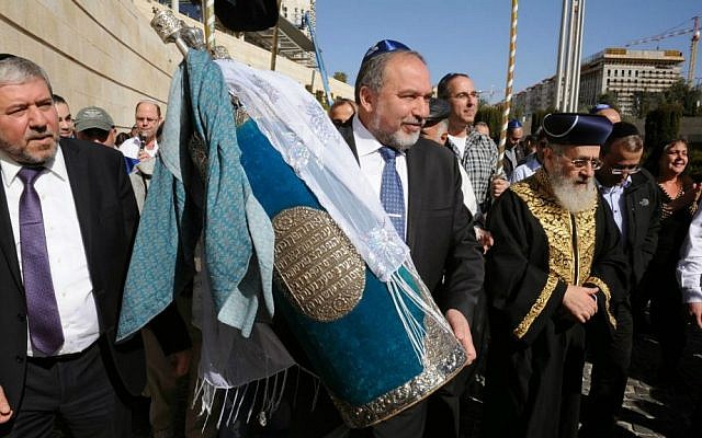 Foreign Minister Avigdor Liberman, center, and Chief Rabbi Yitzhak Yosef, right, carry a Torah scroll in the Foreign Ministry in Jerusalem, January 22, 2015 (photo credit: Elram Mandel/Foreign Ministry) Foreign Minister Avigdor Liberman, center, and Chief Rabbi Yitzhak Yosef, right, carry a Torah scroll in the Foreign Ministry in Jerusalem, January 22, 2015 (photo credit: Elram Mandel/Foreign Ministry)